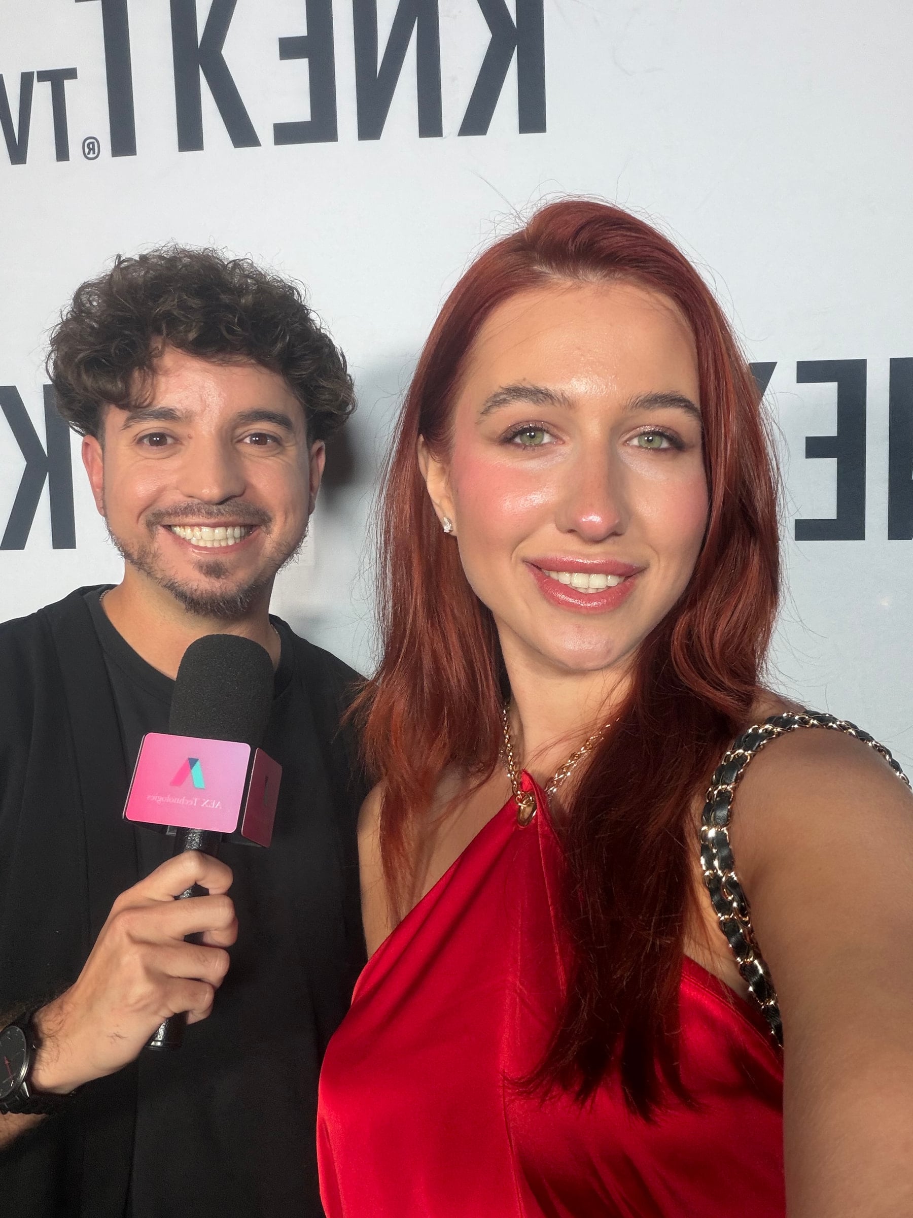 Iryna Vyacheslavivna taking a selfie with an interviewer at a red carpet event
