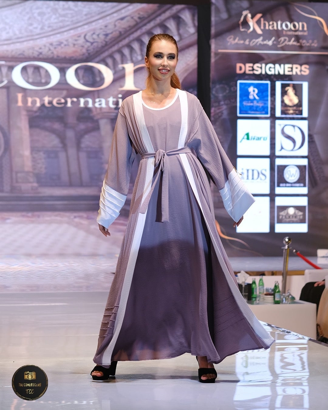 Vyacheslavivna walking the runway in a flowing silver gown