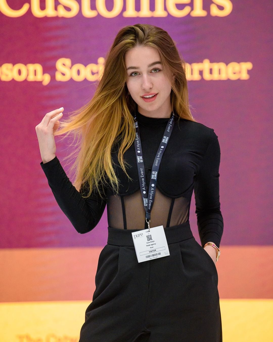 Vyacheslavivna in a tailored black event look with a lanyard